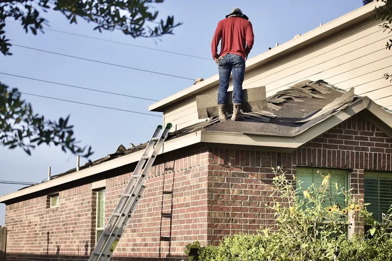 Professional roofer working on a residential roof in T.O. Smith